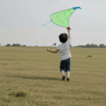 A cheerful child flying a kite, symbolizing adventure and the boundless imagination of childhood.