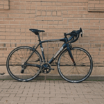 Artistic view of a bicycle leaning on a weathered brick wall, reflecting timeless allure.