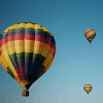 A stunning hot air balloon festival featuring numerous vibrant balloons ascending into the sky.