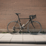 A vintage bicycle leaning against a rustic brick wall in an urban setting.