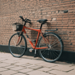 Artistic bicycle scene against a brick wall, offering a glimpse into timeless city life.