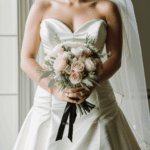 Bride holding a bouquet, radiating grace and wedding day beauty.