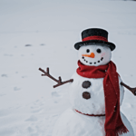 A cheerful snowman wearing a bright red scarf stands in the snow, showcasing the joy of winter creativity.