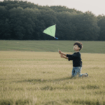 A child running across a grassy field with a colorful kite soaring high in the sky.