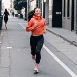 Urban-scenery-loving girl running confidently, reveling in the freedom of city running.