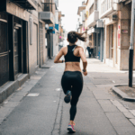 Girl in athletic gear running joyfully on busy city streets, showcasing urban fitness.