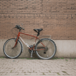 Charming scene of a bicycle against an old brick wall, capturing timeless beauty.