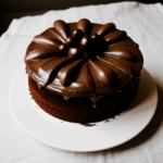 A delicious chocolate cake topped with a glossy layer of frosting, perfect for dessert lovers.
