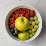 A refreshing bowl of fresh fruits, adding color and health benefits to a kitchen counter.