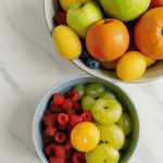 An inspirational arrangement of fresh fruits in a bowl, adding charm and health to a kitchen.