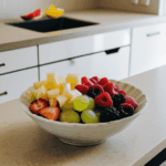 A kitchen counter adorned with a bowl of fresh fruits, exemplifying healthy living and vibrant decor.