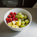 A delightful fruit bowl on a kitchen counter, offering a burst of color and freshness.