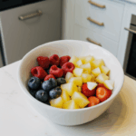A variety of fresh fruits in a bowl, beautifully arranged to enhance a kitchen's decor.