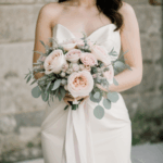 A graceful bride shot featuring her and her bouquet of flowers.