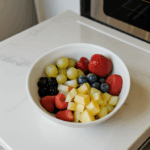 A healthy and colorful fruit bowl on a kitchen counter, showcasing the beauty of fresh produce.