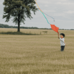 A delightful depiction of a child with a kite, showcasing the happiness found in nature and simple play.