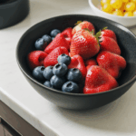 A kitchen counter featuring a bowl of fresh fruit, highlighting vibrant colors and natural beauty.