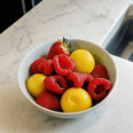 Artfully arranged fresh fruits in a bowl, bringing life and color to a kitchen setting.