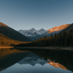 Majestic view of a mountain lake at sunrise, capturing the peaceful morning reflections.