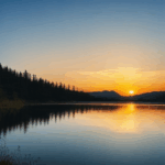 Dawn light illuminating a mountain lake's tranquil beauty.
