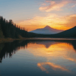 Nature's serene sunrise scene over a mountain lake.
