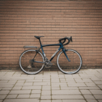 A serene setting featuring a bicycle leaning against a classic brick wall, perfect for capturing memories.