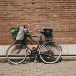 Bicycle placed against a brick wall, highlighting the rustic textures and classic elegance.