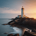 The silhouette of a lighthouse against a vivid sunset sky on a rocky coastline.