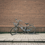 Classic bicycle poised elegantly against a textured brick wall, offering artistic inspiration.