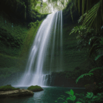 A serene view of a jungle waterfall, surrounded by abundant greenery and natural beauty.