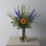 Stylish vase of wildflowers adding rustic charm and vibrant color to any interior space.