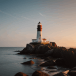 A picturesque lighthouse at sunset on a rocky coast, with the sea shimmering below.