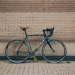 An elegant composition with a bicycle against a brick wall, offering creative inspiration.