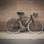 Urban charm captured with a bicycle set against a brick wall, ideal for photography lovers.