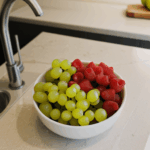 A colorful display of fresh fruits arranged beautifully, adding vibrancy to a kitchen counter.