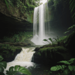 A breathtaking view of a jungle paradise with a stunning waterfall and lush surroundings.