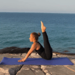 A peaceful yoga scene by the coastline, inviting relaxation.